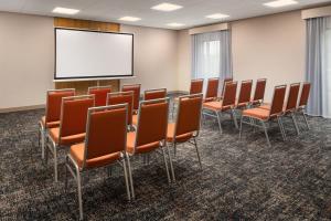 a conference room with chairs and a projection screen at Hampton Inn Neptune in Neptune City +25 photos