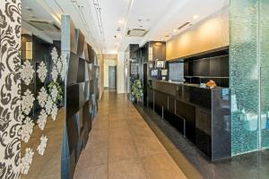 a hallway in a building with black and white at Hotel 81 Kovan in Singapore