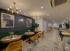 a restaurant with tables and chairs and a couch at Hotel Heaven Luxes Opp Miraj Cinemas in Hyderabad +7 photos