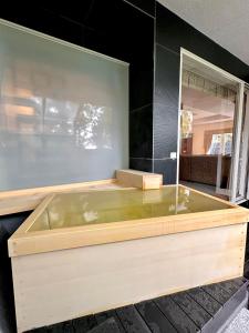 a large wooden bath tub in a room at ISANA Resort in Ito