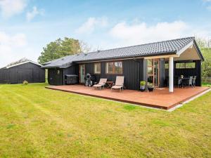 a modular home with a deck and patio at 6 person holiday home in Rømø in Lakolk