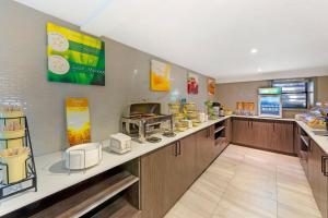 a fast food restaurant with a counter with food at Quality Inn Centre-Ville in Montréal