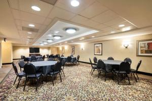 a conference room with tables and chairs in it at Clarion Collection Hotel Arlington Court Suites in Arlington