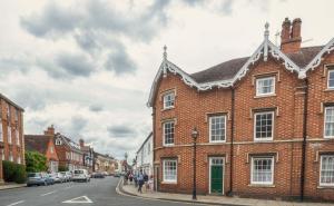 a brick building on a street with people walking down the street at Luxury Town Centre Apartment in Stratford-upon-Avon