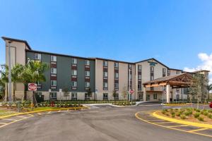a large building with a street in front of it at WoodSpring Suites Tamarac in Tamarac