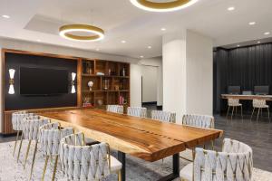 a conference room with a large wooden table and chairs at Radisson Blu Vancouver Airport Hotel & Marina in Richmond
