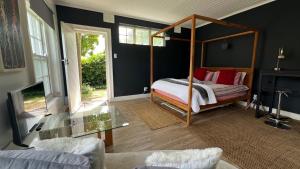 a bedroom with a canopy bed in a room at Villa Barry in Hout Bay
