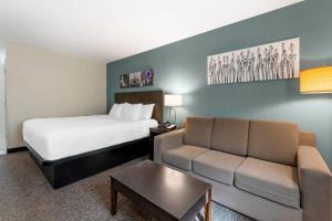 a hotel room with a bed and a couch at Sleep Inn & Suites Wisconsin Dells - Lake Delton in Wisconsin Dells +41 photos