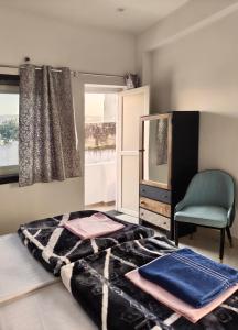 a bedroom with a bed and a mirror and a chair at Rajguru guest house in Pushkar +35 photos