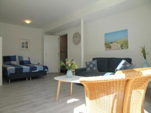 a living room with a couch and a bed at Stunning apartment in Schoorl, North Hollandâ you can bike to the beach in Schoorl