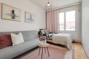 a living room with a couch and a bed and a window at Central Luxury Stay w Vintage Charm & Sauna in Helsinki +23 photos