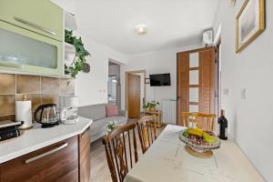 a kitchen and dining room with a table and chairs at Apartment Neda in Rabac - Bay View in Rabac