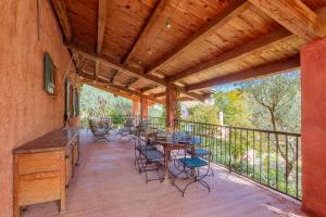 a patio with a table and chairs on a deck at Gite Baba in Puget-Ville