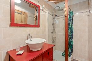 a bathroom with a sink and a shower at Gite Baba in Puget-Ville