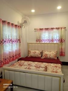 a bedroom with a bed with pink and white curtains at Rocky Jungle Bungalows in Koh Rong