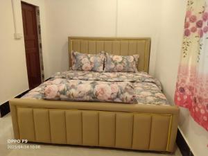 a bedroom with a bed with a yellow bed frame at Rocky Jungle Bungalows in Koh Rong