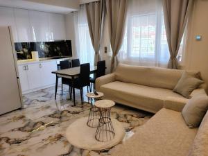 a living room with a couch and a table at Modern central apartment in Serres +22 photos