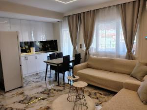 a living room with a couch and a table at Modern central apartment in Serres