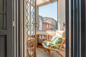 a view of a balcony with a chair and a window at La Ruche des Abeilles in Avignon