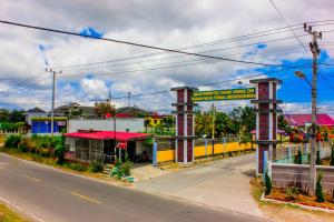 an empty street with a building on the side of the road at Penginapan The Guardians in Silangit International Airport