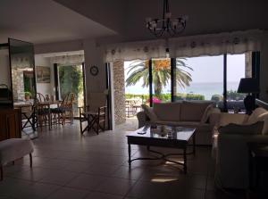 a living room with a couch and a table at Beach Front Chanioti in Polykhrono