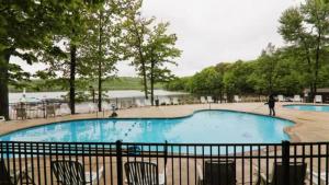 a large swimming pool with a person walking around it at The Boulder Inn by AvantStay Indoor Hot Tub Game Room Outdoor Fire Pit in Lake Harmony
