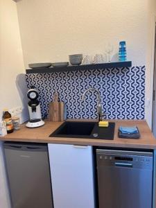 a kitchen with a sink and a counter top at Aquamarine - Central and cozy in Kassel