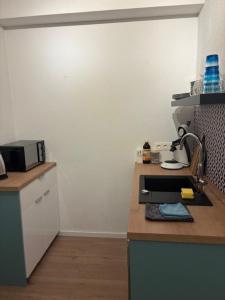 a kitchen with a counter top with a printer at Aquamarine - Central and cozy in Kassel