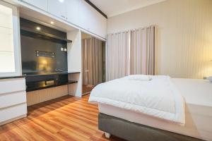 Ένα ή περισσότερα κρεβάτια σε δωμάτιο στο Fasco Palagan D2 Homestay Jogja