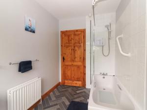 a bathroom with a shower and a bath tub at Fort Lodge in Limerick +32 photos