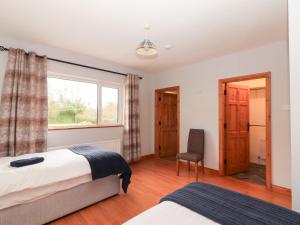 a bedroom with two beds and a window at Fort Lodge in Limerick