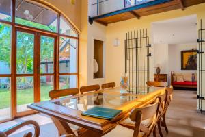 a dining room with a glass table and chairs at Villa Inavni in Talawatugoda +38 photos