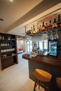 a kitchen with a bar with a bar stool at Eterrano Seaside Retreat in Parga