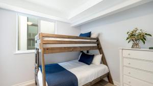 a bedroom with a bunk bed and a window at Sleeps 18 Steps to the Beach Shops Eateries Ocean Views Patio Fire Pit in Newport Beach