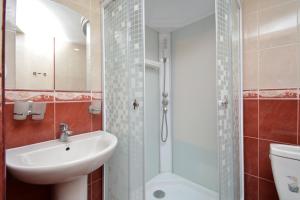 a bathroom with a sink and a toilet and a shower at Loft Apartment in the heart of Yerevan in Yerevan +10 photos