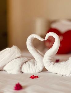 two towels shaped like swans sitting on a bed at Riverview Bentota in Bentota +8 photos