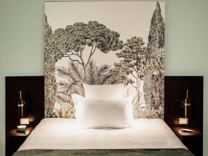 a bedroom with a bed with a mural on the wall at Hotel Mercure Roma Corso Trieste in Rome +113 photos