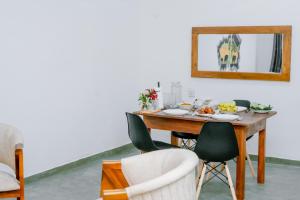 a dining room table with chairs and a mirror at 7 S Villa & Cottage in Kamburugamuwa +23 photos