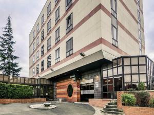 a large building with a tree in front of it at Mercure Cergy Pontoise Centre in Cergy