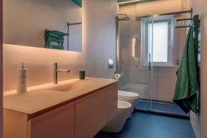 a bathroom with a sink and a toilet and a shower at Drea Acitrezza Luxury Home in Acitrezza +27 photos