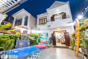a house with a water park in front of it at Villas Hồ Bơi HM Bãi Sau Thoáng Mát Sân BBQ in Vung Tau