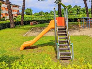 an orange slide in a park with a ladder at Last Minute Booking in Peschiera del Garda
