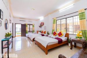 a room with four beds in it with windows at Villas Hồ Bơi HM Bãi Sau Thoáng Mát Sân BBQ in Vung Tau +38 photos
