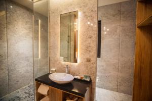 a bathroom with a sink and a glass shower at LE LE Motel in Pingtung City