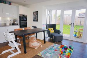 a kitchen with a table and a teddy bear in a room at En-suite Double Bedroom with Pentland Hill View in Edinburgh
