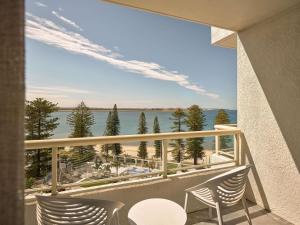 a balcony with two chairs and a view of the ocean at The Brighton Hotel Sydney - Mgallery Collection in Sydney +116 photos