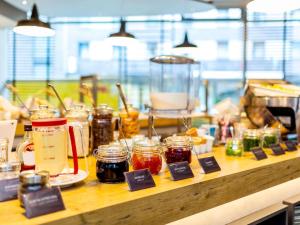 a counter with many jars of jam on it at ibis Hotel Hamburg St. Pauli Messe in Hamburg