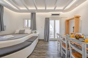 a bedroom with a large bed and a dining room at Depis luxury villas naxos in Plaka +168 photos