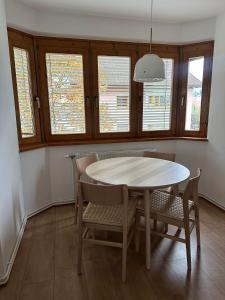 a dining room with a table and chairs and windows at Alpine Oasis in Hermagor +14 photos