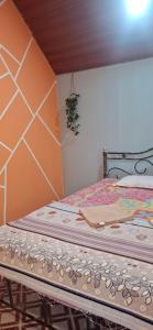 a small bedroom with a bed with a wooden headboard at The Green resort goa in Canacona